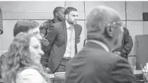  ?? GIORGIO VIERA/EFE ?? Pablo Ibar, center, is handcuffed after a jury finds him guilty of the 1994 murders of Casimir Sucharski, Sharon Anderson and Marie Rogers. In the foreground are prosecutor­s Chuck Motron (left), Katya Palmiotto and William Sinclair.