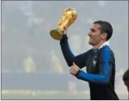  ?? MARTIN MEISSNER — THE ASSOCIATED PRESS ?? France’s Antoine Griezmann celebrates with the trophy after his team won the World Cup over Croatia on July 15.