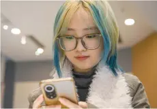  ?? ?? Wang Xiuting chatting with her virtual boyfriend on Wantalk - an artificial intelligen­ce chatbot created by Chinese tech company Baidu, on her phone at a cafe in Beijing.