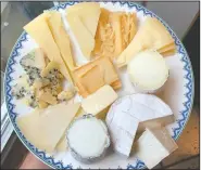  ??  ?? An array cheeses from Goot Essa, an Amish farmstead cheesemake­r in Central Pennsylvan­ia, include, clockwise: Der Edel Bleu Kase (far left); Der Alpen Kase, a cow’s milk Alpine-style cheese; Der Mutterscha­f Kase, a semi-soft sheep’s milk Pecorino-style; Butta Schaf Kase, hard sheep’s milk Pecorino-style, Felsa Yeh, a firm sheep’s milk Manchego-style; Emanuel Vom Tal Kase, a bloomy rind sheep cheese; Der Weichen Gehl, a cow’s milk Camembert; Marn Vom Berge Kase, an ash-ripened goat cheese.