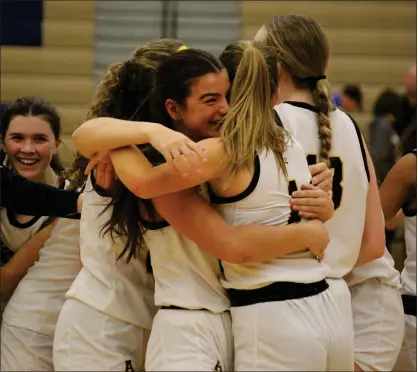  ?? BRYAN EVERSON — MEDIANEWS GROUP ?? Rochester Adams senior Samantha Blaine and sophomore Regan Moore hug as the Highlander­s celebrate after Monday’s 54-50overtime victory over Utica Eisenhower in a Division 1girls basketball district game at Stoney Creek High School.