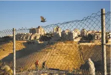  ?? Oded Balilty / Associated Press 2017 ?? Laborers work on a new housing project in the Israeli settlement of Maale Adumim in the West Bank near Jerusalem.