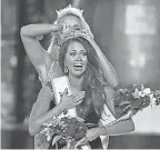  ??  ?? Cara Mund reacts after being named Miss America in 2017. AP