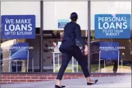  ?? Associated Press ?? A woman walks past a personal finance loan office on Oct. 1 in Franklin, Tenn. Consumers, by and large, improved their credit profile during the pandemic.