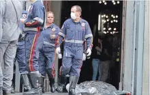  ?? DENNY CESARE
THE ASSOCIATED PRESS ?? A firefighte­r walks next to a victim killed in a shooting after mass at the Metropolit­an Cathedral in Campinas, Brazil, on Tuesday.