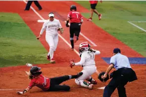  ?? The Canadian Press ?? Canada’s Victoria Hayward, left, is tagged out by Mexico catcher Sashel Palacios during a softball game at the 2020 Summer Olympics, Tuesday, in Yokohama, Japan.