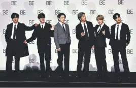  ?? BE (Deluxe Edition) ?? BTS members (from far left) V, Jin, Jung Kook, RM, Jimin and JHope pose for a photo session during a press conference on BTS’ new album
in Seoul on Nov 20.