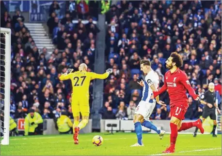  ?? GLYN KIRK/AFP ?? Liverpool’s Egyptian midfielder Mohamed Salah (right) celebrates after scoring from the penalty spot during the Premier League match against Brighton and Hove Albion at the American Express Community Stadium in Brighton on Saturday.