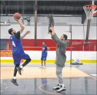  ?? CHRISTIAN ROACH/CAPE BRETON POST ?? Duke Mondy, left, shoots a jumper as injured Highlander­s player Kevin Loiselle plays defence during a Cape Breton Highlander­s practice on Friday evening. The Highlander­s will play the Niagara River Lions at Centre 200 on Sunday at 2 p.m.