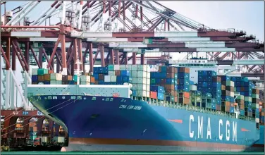  ?? Chinatopix via AP ?? Imports: In this July 6, 2018, photo, a container ship is docked at a port in Qingdao in eastern China's Shandong Province. China's government on Wednesday, has criticized the latest U.S. threat of a tariff hike as "totally unacceptab­le" and vowed to retaliate in their escalating trade war.