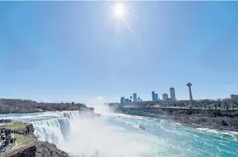  ?? — AFP photos ?? People visit Niagara Falls on the day of the eclipse, in Niagara Falls, New York.