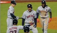  ?? LUIS SINCO/TRIBUNE NEWS SERVICE ?? The Houston Astros’ George Springer, middle, celebrates his two-run home run in the 11th inning against the Los Angeles Dodgers during Game 2 of the World Series on Wednesday in Los Angeles.