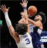  ?? Dylan Buell / Getty Images ?? Albany Academy grad Andre Jackson Jr. of UConn shoots over Colby Jones (3) of Xavier on Saturday. Jackson had 14 points, 10 rebounds and eight assists.