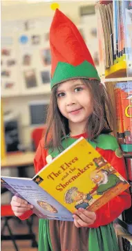  ??  ?? Seasonal Kettins Primary School pupil Sophie Samani with her favourite book, The Elves and The Shoemakers