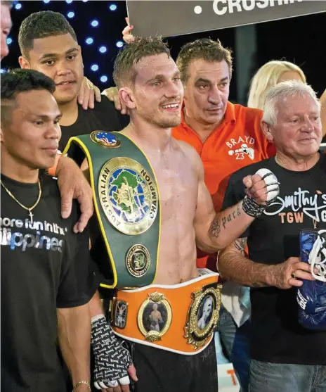 ?? Photo: Kevin Farmer ?? TEAM EFFORT: Steve Spark celebrates with his supporters (from left) Jack Asis, Corban Kanaveilom­ani, trainer Brendon Smith and Bert Hornery after his win this month over Japan’s Taisho Ozawa for the WUC Brayd Smith super lightweigh­t title at Rumours Internatio­nal.