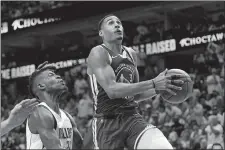  ?? TONY GUTIERREZ/AP PHOTO ?? Golden State Warriors guard Jordan Poole (3) attempts a layup as Dallas Mavericks forward Reggie Bullock defends during Game 4 of the NBA playoffs Western Conference finals on Tuesday in Dallas.