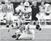  ?? NELL REDMOND/AP ?? Miami Dolphins' Xavien Howard returns an intercepti­on against the Carolina Panthers in on Friday night.