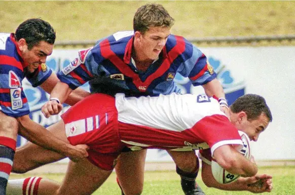  ??  ?? CUP KINGS: Toowoomba Clydesdale­s player Nathan Murphy tackles a Redcliffe Dolphins player in the 2001 Q-Cup final. The Clydesdale­s won the final to secure thier second Q-Cup title.