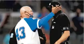  ?? GETTY TODD KIRKLAND/ ?? Braves manager Brian Snitker argues after a replay upheld a call at the plate Sunday night in which the Phillies’ Alec Bohm scored the eventual winning run.