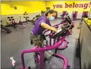  ?? Mel Melcon Los Angeles Times ?? LENTERRA DANIELS disinfects gym equipment at a Planet Fitness in Inglewood on Monday.