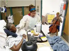  ?? TOM SAMPSON/ AP ?? Cellist Martha Vance plays for a patient at Medstar Georgetown University Hospital in Washington DC. Musicians and dancers are part of the Georgetown Lombardi Comprehens­ive Cancer Center’s arts and humanities program.