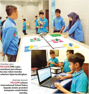  ?? (Gambar kanan) ?? PELAJAR SMK Lajau membuat percubaan ke atas robot mereka sebelum dipertandi­ngkan. PELAJAR Labuan Internatio­nal School fokus kepada sistem protokol komputer untuk Robot mereka.