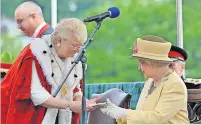  ?? ?? Royal visit Provost Elizabeth Grant presents the keys to the City of Perth to the Queen in 2012. Pic: Richard Wilkins