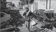  ??  ?? A man surrounded by rubble following what civil soceity groups say was a US-led airstrike in western Mosul. (CNN)