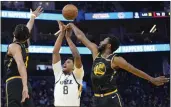  ?? JEFF CHIU — THE ASSOCIATED PRESS ?? Warriors forward Andrew Wiggins (22) blocks a shot by Utah Jazz forward Rudy Gay (8) during the second half in San Francisco on Sunday.