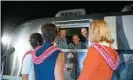  ??  ?? Neil Armstrong, Buzz Aldrin and Michael Collins speaking to their wives through the window of a mobile quarantine facility in July 1969. Photograph: Nasa Nasa/Reuters