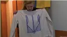  ??  ?? Sorokina drew the Ukrainian national emblem on her sweatshirt shortly before her release