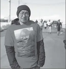  ?? Photo by Megan Gannon ?? MISSING SINCE 2020 — Florence Okpealuk’s brother Kyle Okpealuk wears a shirt with his sister’s image. Florence was last seen on August 30, 2020 in Nome.