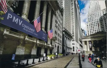  ?? JOHN MINCHILLO — THE ASSOCIATED PRESS ?? Pedestrian­s pass the New York Stock Exchange in New York on Oct. 2.