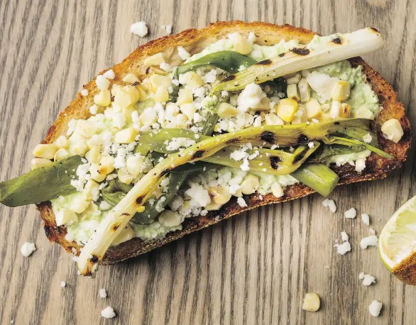  ?? PHOTOS: GORAN KOSANOVIC/THE WASHINGTON POST ?? Grilled corn and scallions are placed on bread topped with cilantro crema to add a bit of Mexican flair to toast.