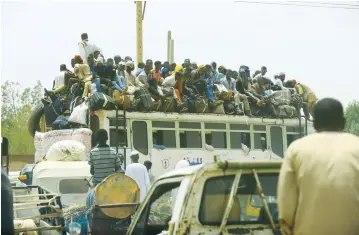  ?? (Mohamed Nureldin Abdallah/Reuters) ?? PEOPLE RIDE a crowded bus as they return to their families ahead of the Eid al-Adha festival in Khartoum on Sunday.