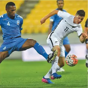  ?? Photo: OFC Media ?? Fijian mdfielder Dave Radrigai (left) defends against the All Whites in Wellington in 2017 during the 2018 World Cup qualifiers. New Zealand won 2-0.