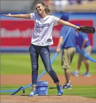  ?? ASSOCIATED PRESS ?? Actress Jessica Alba gestures after throwing out the first pitch prior to the Brewers’ game at Dodger Stadium on Sunday.