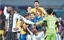  ?? REUTERS ?? Japan players celebrate after their comeback 2-1 win on Wednesday