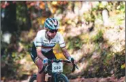  ?? (Special to NWA Democrat-Gazette/Kai Caddy) ?? UCI gravel world champion Kasia Niewiadoma climbs a hill 55 miles in the Big Sugar Gravel race Saturday in Bentonvill­e. Niewiadoma soloed to a near 9-minute victory.