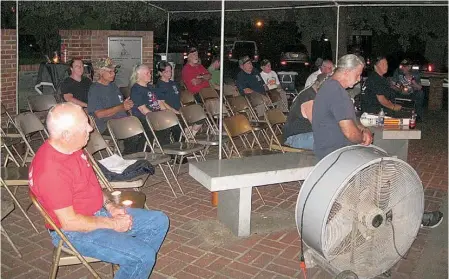  ?? Staff photo by Greg Bischof ?? n Former military personnel and their families listen to a presentati­on during the opening ceremony of the 30th annual POW-MIA Vigil in Texarkana.