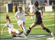  ?? Brian A. Pounds / Hearst Connecticu­t Media ?? St. Joseph’s Anastasia Kydes, left, and Andriana Cabral converge on the ball with Trumbull’s Sophia Lowenberg during the first half on Thursday.