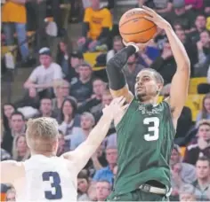  ?? Eli Lucero, Logan Herald Journal via AP ?? Gian Clavell, taking a shot for CSU over Utah State’s Sam Merrill last season, believes he has what it takes to play in the NBA.