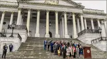  ?? Kenny Holston / New York Times ?? Members of the House and Senate hold a moment of silence to mark one million American lives lost to COVID-19 on the steps of the Capitol on Thursday.