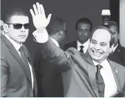  ?? AP ?? Egyptian President Abdel-Fattah el-Sissi waves as he arrives to the opening ceremony of the new section of the Suez Canal in Ismailia, Egypt. A new 54-article anti-terrorism bill signed into law by el-Sissi was announced yesterday.