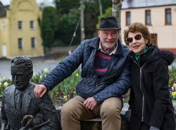  ??  ?? RICH PICKINGS: Reporter Liam Collins with local woman Gabrielle Brady at the Seamus Ennis statue in The Naul, the north county Dublin village where the €175m-winning EuroMillio­ns ticket was sold. Photo: Mark Condren