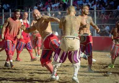  ??  ?? A sinistra Luca Mulè, 32 anni, in un’azione di gioco durante il torneo vinto dal suo Colore , i Rossi, l’anno scorso Sotto con le protezioni anti Covid durante un turno di lavoro in un ospedale di Bologna