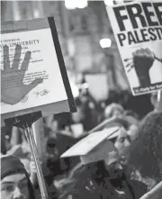  ?? MICHAEL M. SANTIAGO/GETTY IMAGES ?? People march as they gather to protest the banning of Students for Justice in Palestine (and Jewish Voice for Peace at Columbia University on Nov. 20 in New York City.