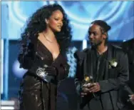  ?? THE ASSOCIATED PRESS ?? Rihanna, left, and Kendrick Lamar accept the award for best rap/sung performanc­e for “Loyalty” at the 60th annual Grammy Awards.