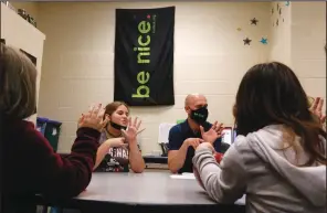  ?? (AP/Martha Irvine) ?? Behavior specialist Eric Clark (center right) leads a group of fifth-graders in a mindfulnes­s exercise Dec. 2 in Paw Paw, Mich.