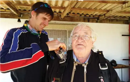  ?? Photo: Sue Maclennan ?? Andem instructor Gerrit van Zyl helps Duncan Greaves get kitted out to jump from 10 000 feet last Friday, in celebratio­n of his 80th birthday.